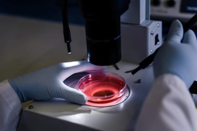imgi_27_closeup-shot-person-studying-coronavirus-particles-with-microscope-scaled